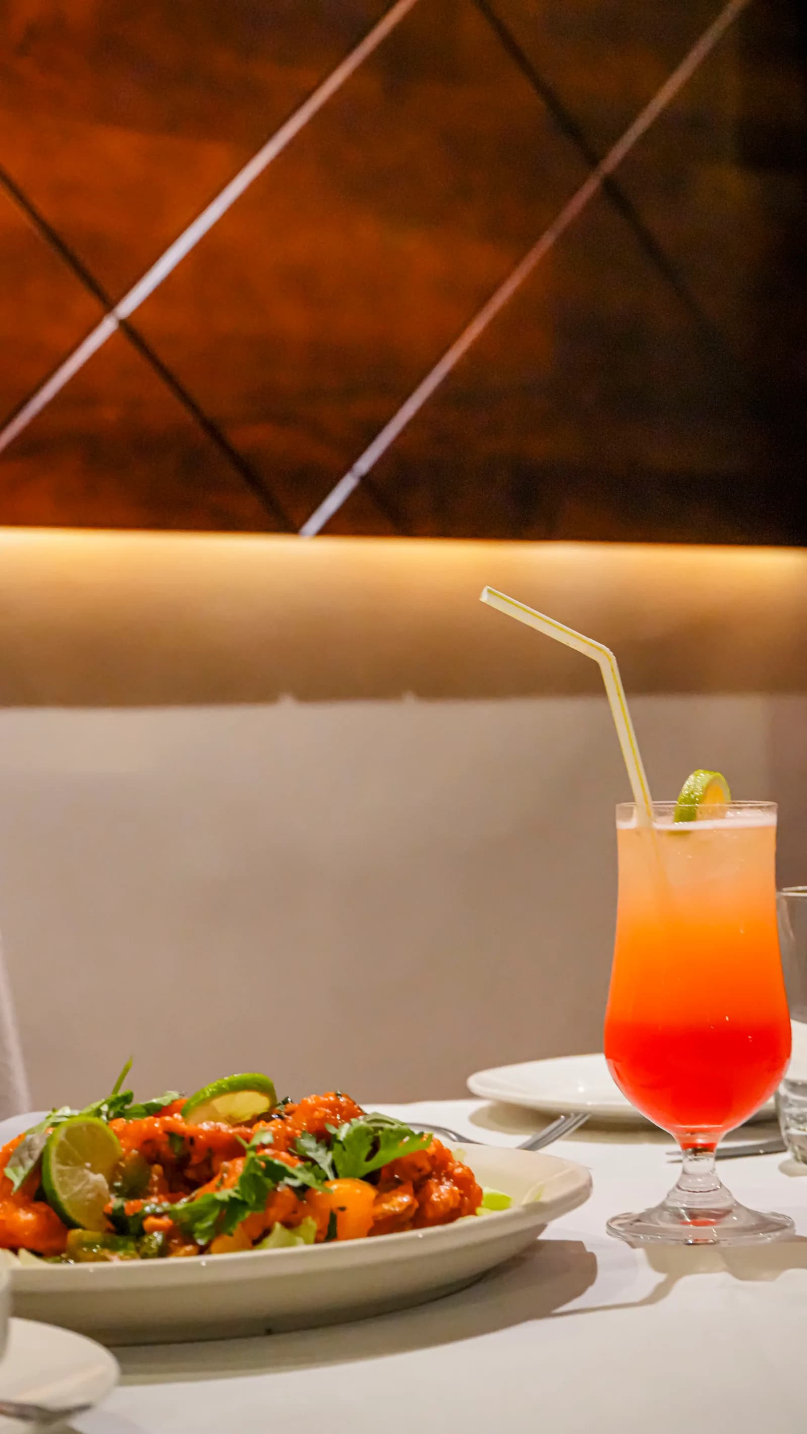 A vivid tropical cocktail on a dressed table